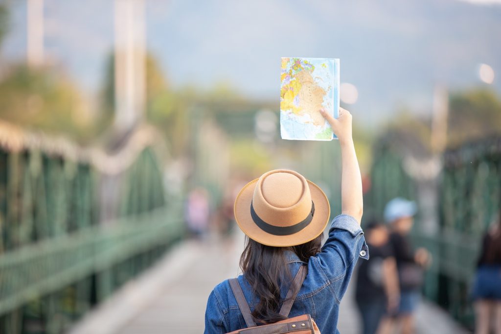 female tourists hand have happy travel map